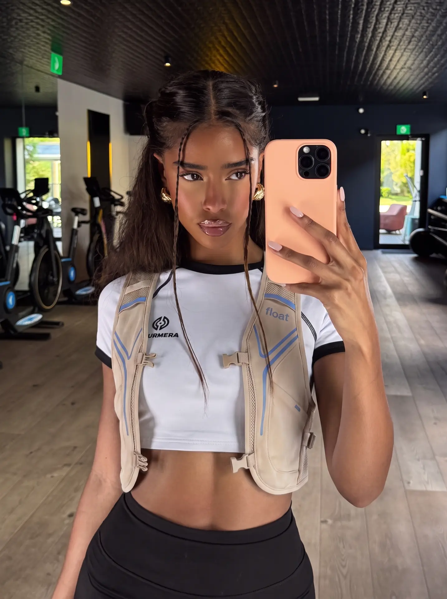 Gym mirror selfie in the Bone FLOAT Vest 01